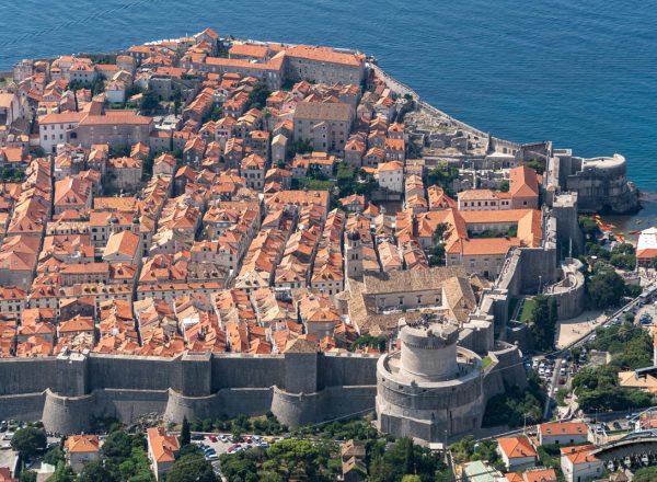 An aerial view of Dubrovnik city showcasing the distinctive red roofs and the urban landscape, Croatia