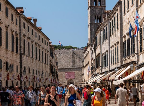 Group of girls walking down a Stradun street lined with historic buildings, Dubrovnik, Croatia