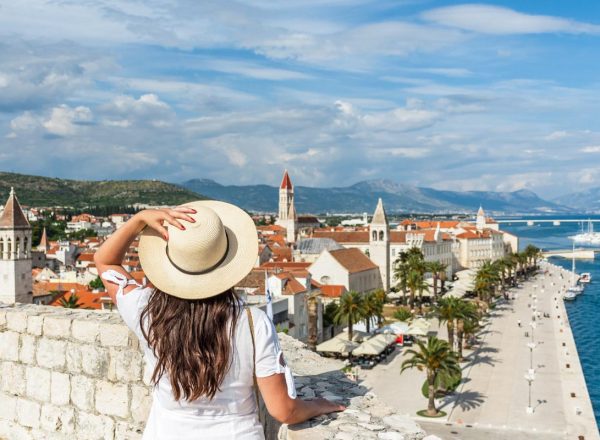 rear-view-woman-standing-city-walls-looking-idyllic-seaside-town-trogir-croatia